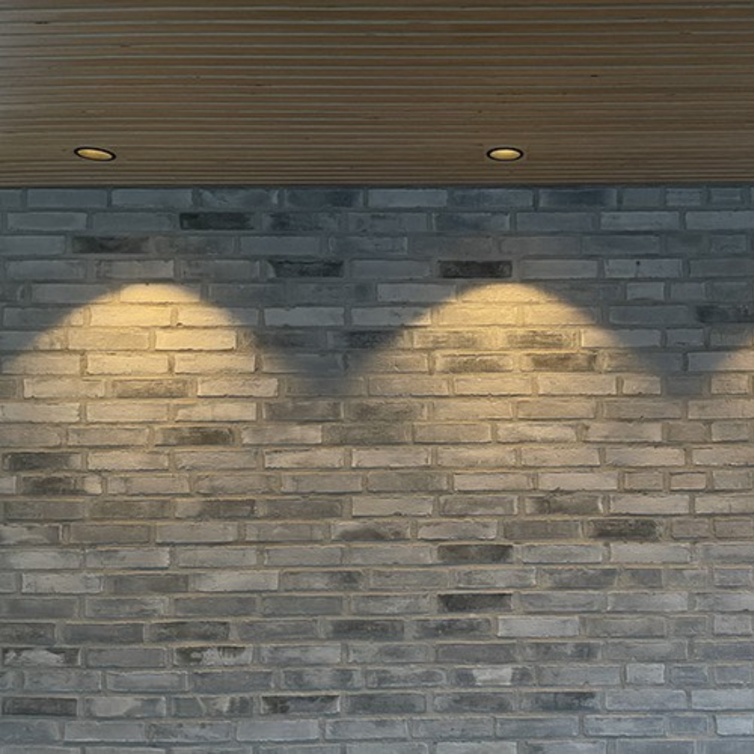 Flere LED spots i loft, der lyser væggen op med varm hvid belysning.